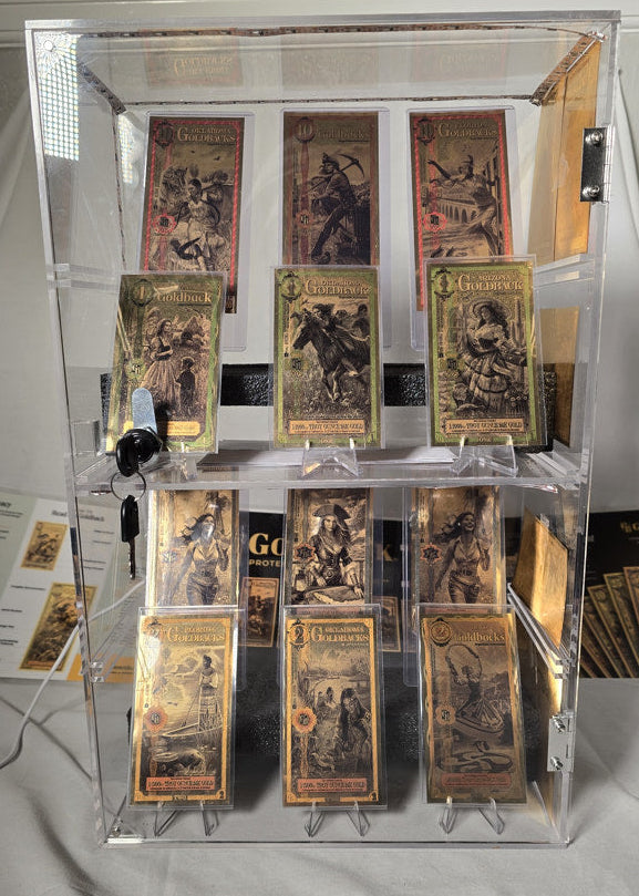 Top-down view of Goldback notes organized in a locking acrylic display case